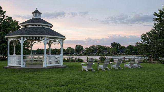 Gazebo and empty chairs on St. Michaels park grass at evening