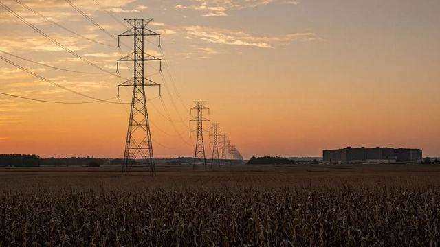 Rural Talbot field under transmission lines at dusk