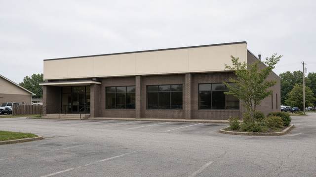 Exterior of a commercial bowling center on a commercial strip