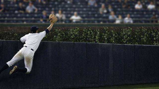 Coors Field outfield wall under night lights
