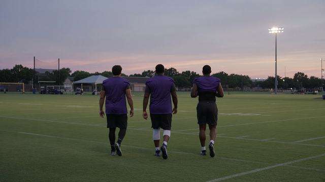 Baltimore Ravens players on the practice field