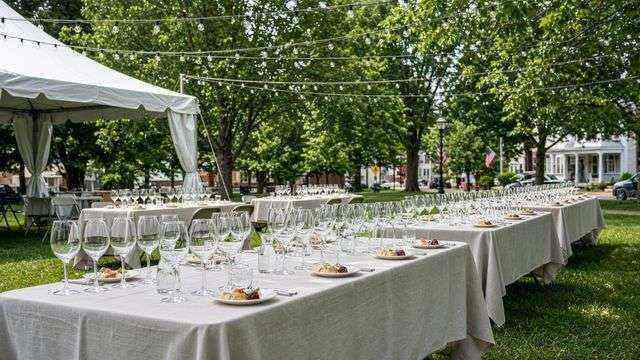 Outdoor tasting tables with wine glasses at a small-town festival