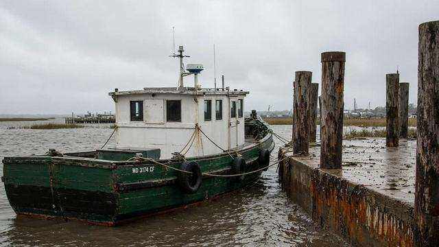 Workboat at a muddy dock after rain